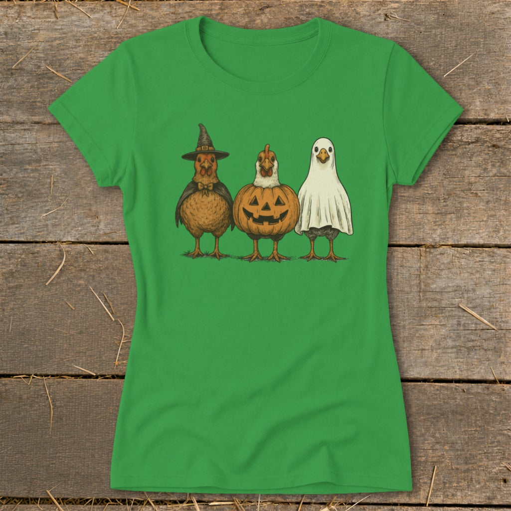 Three chickens dressed in Halloween costumes: witch, pumpkin, and ghost.