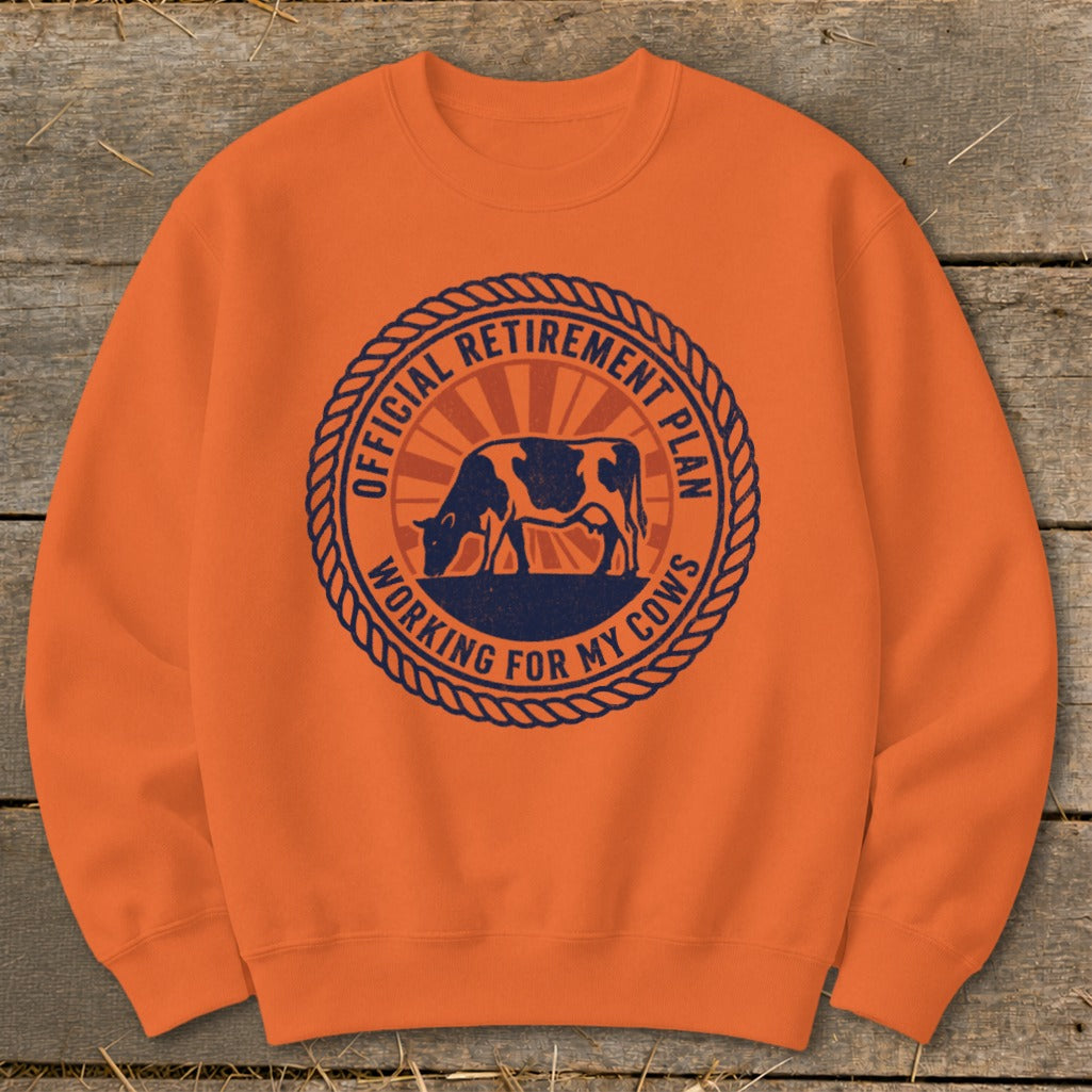 Orange crewneck sweatshirt with a circular graphic featuring a cow and text.