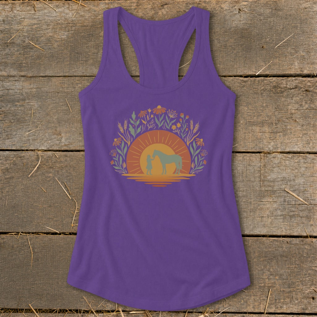 Purple tank top with girl and horse silhouette against sunset and floral border.