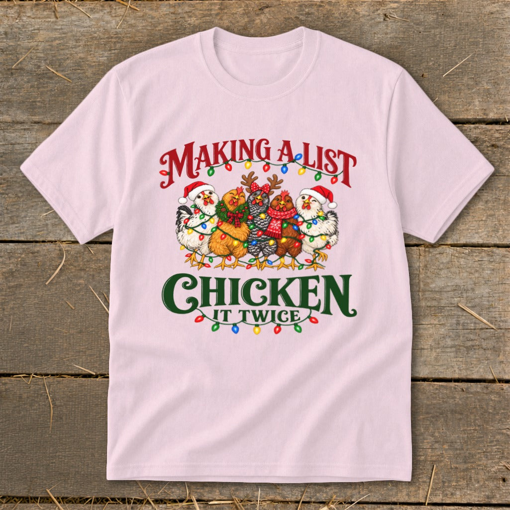 Pink t-shirt with five chickens wearing Santa hats and decorated with Christmas lights.