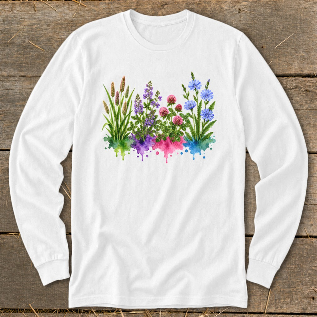 White long-sleeved t-shirt featuring a watercolor graphic of colorful wildflowers over matching paint splatters on a wooden background.