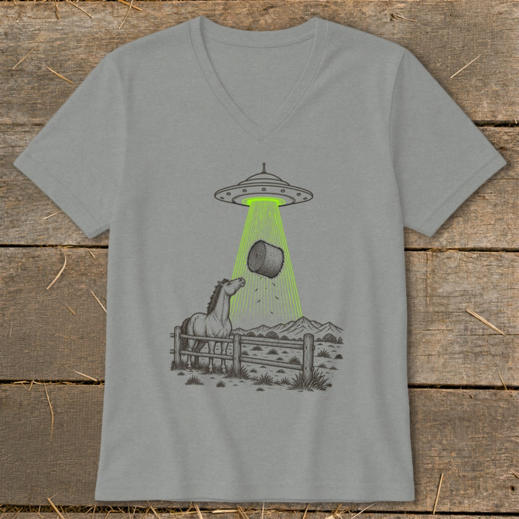 UFO beaming up a hay bale with a curious horse watching.