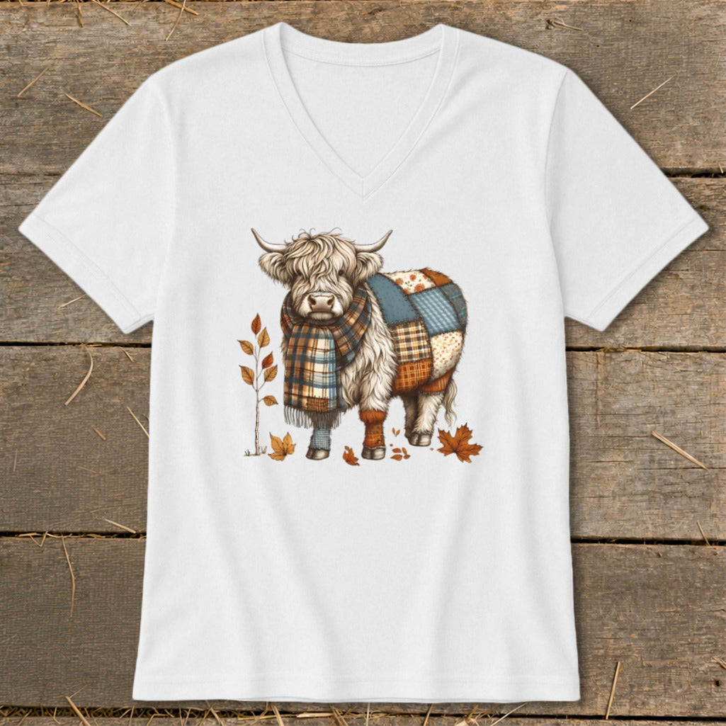 Highland cow with plaid scarf and patchwork body on a white v-neck shirt.