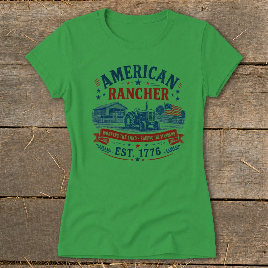Green t-shirt with "American Rancher" text, tractor, barn, and American flag graphic.