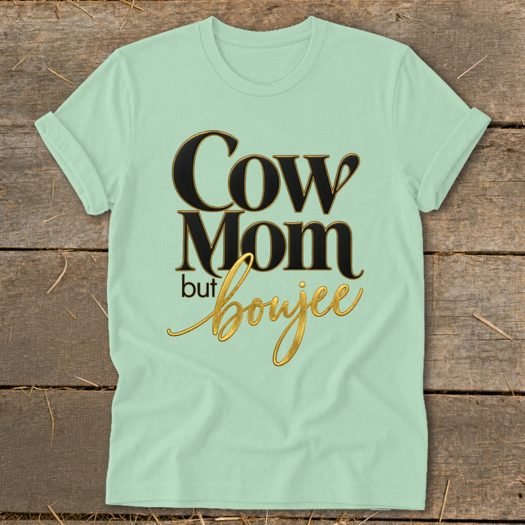 Light green t-shirt with "Cow Mom but boujee" text in black and gold.