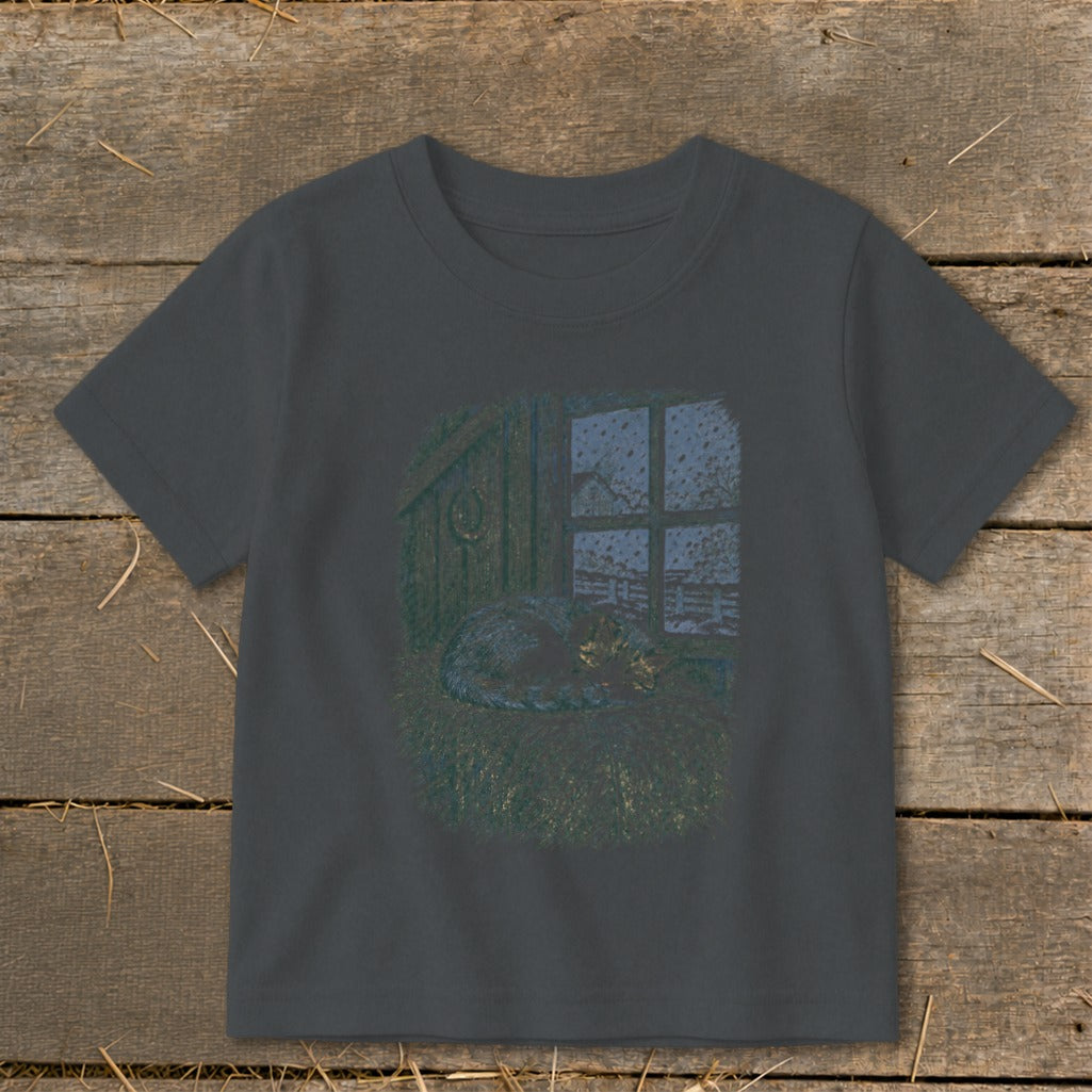 Cat sleeping on hay near window with snow outside, horseshoe on wall.