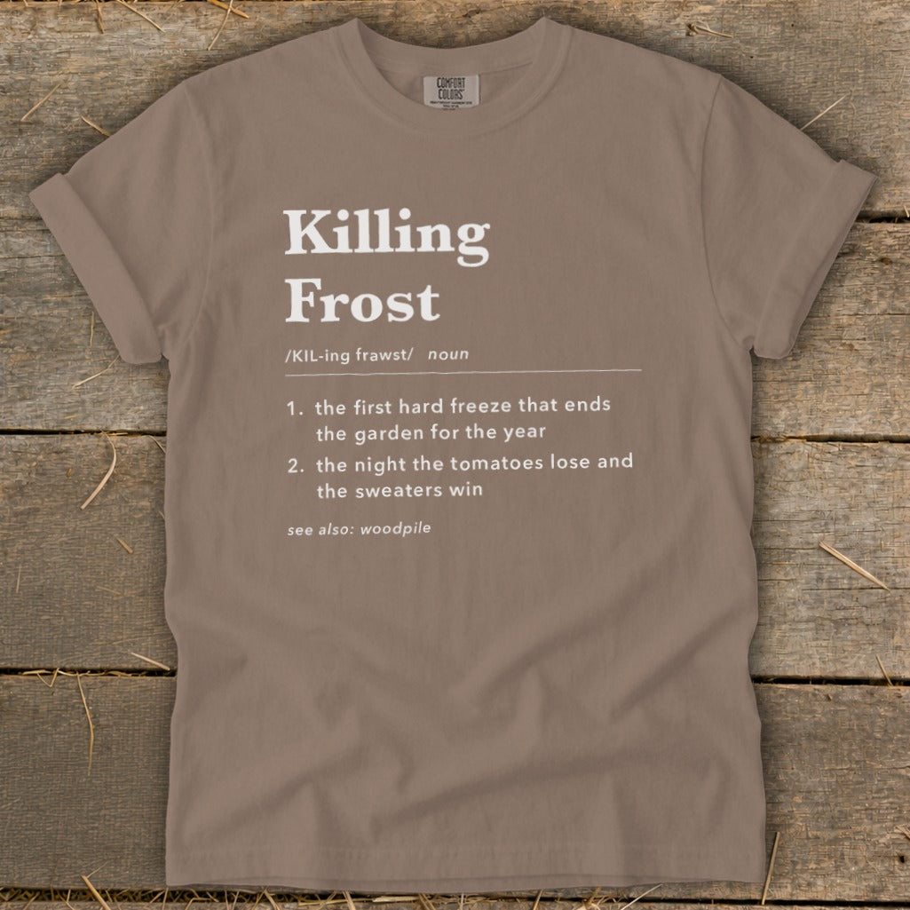 Brown t-shirt featuring dictionary-style text defining "Killing Frost" with a humorous second definition.