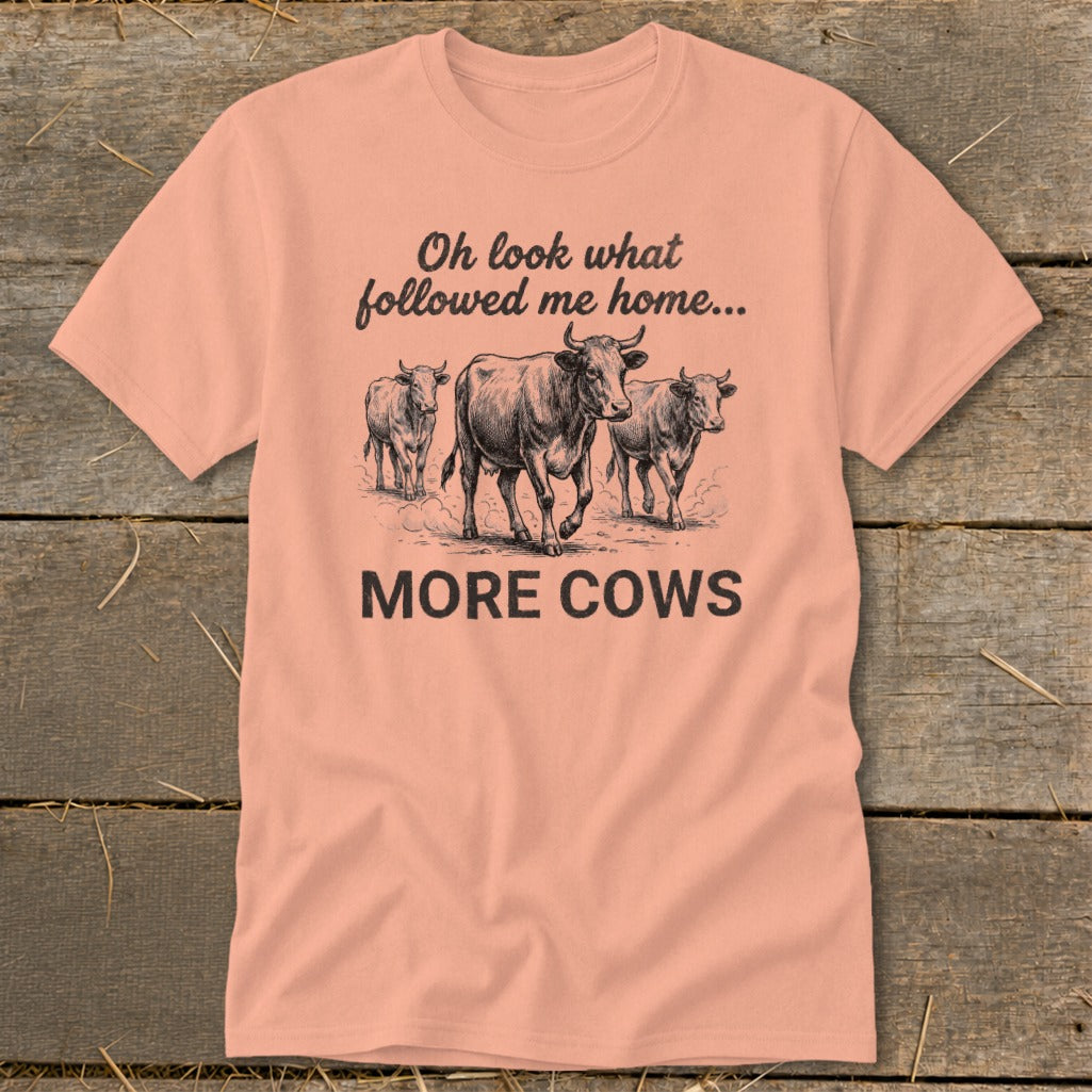 Peach t-shirt with three cows and text "Oh look what followed me home... MORE COWS".