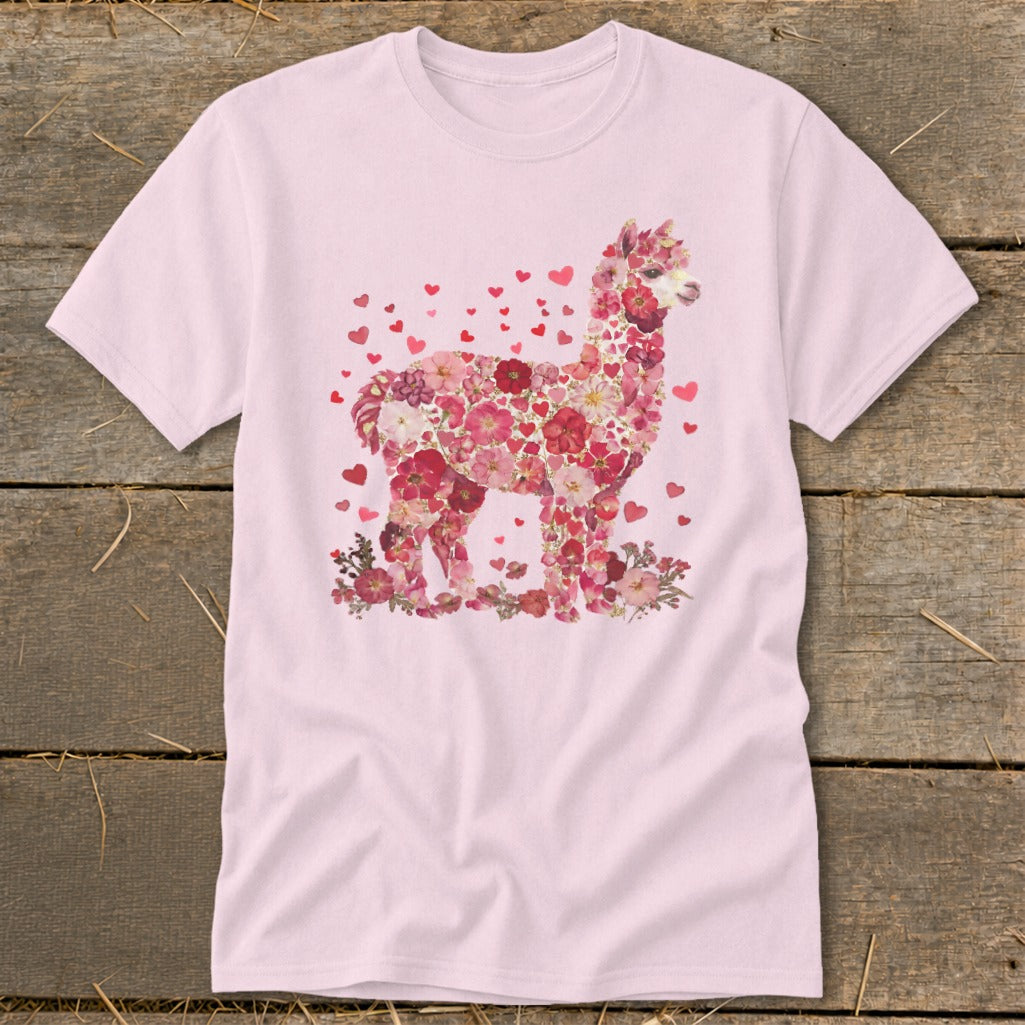 Pink t-shirt featuring an alpaca silhouette filled with pink and red flowers and hearts.