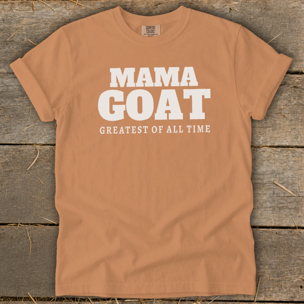 Orange t-shirt with "MAMA GOAT GREATEST OF ALL TIME" printed in white.
