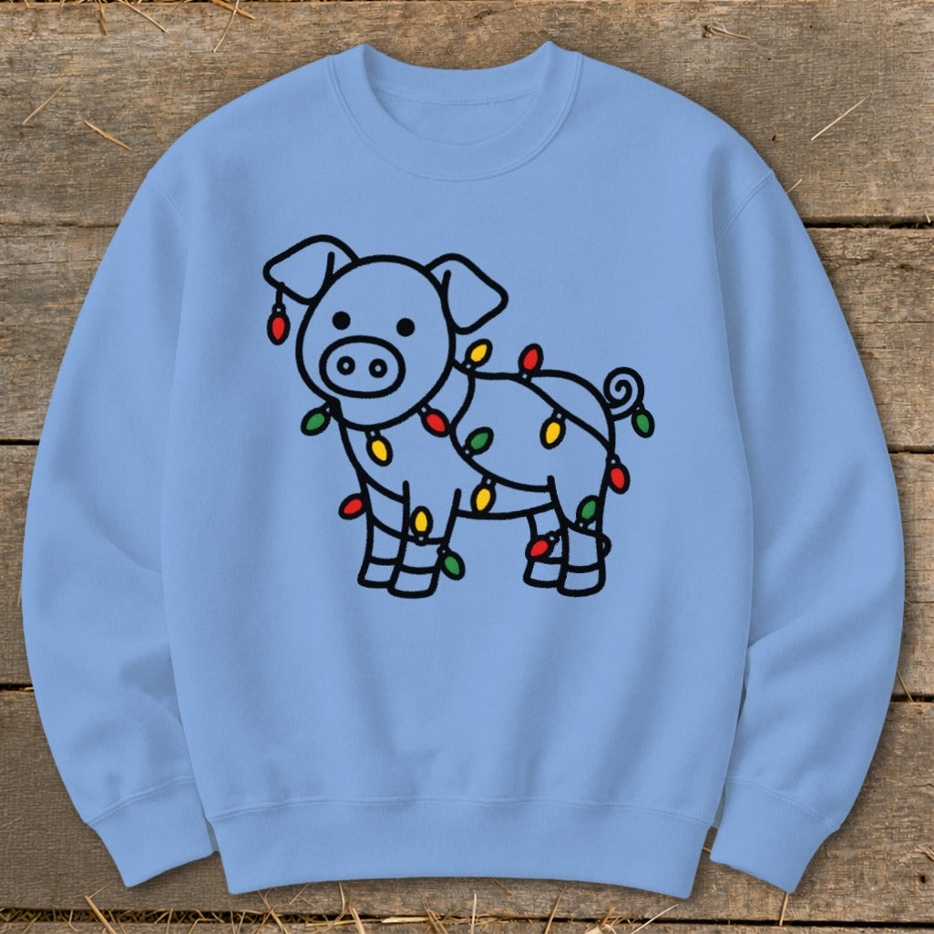 A light blue crewneck sweatshirt featuring a cartoon pig wrapped in colorful Christmas lights.