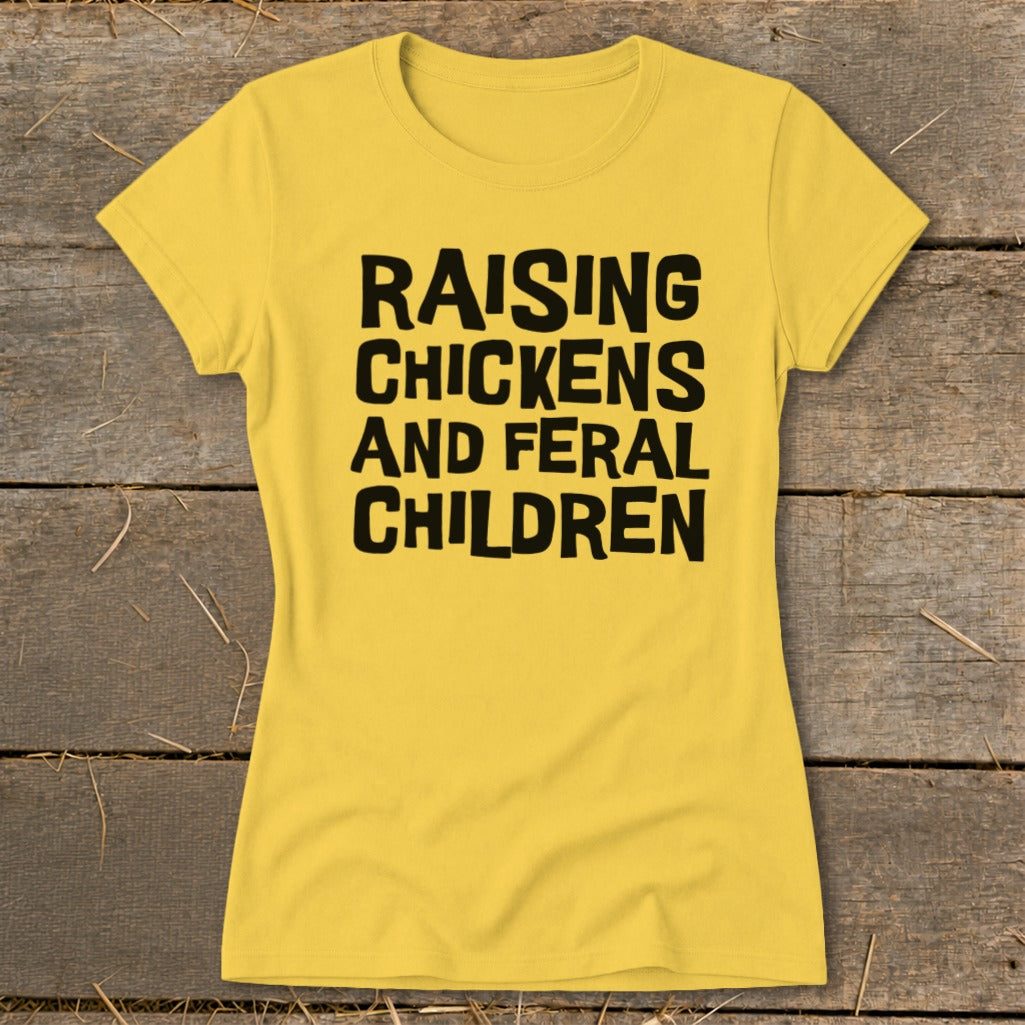 Yellow t-shirt with black text "RAISING CHICKENS AND FERAL CHILDREN"