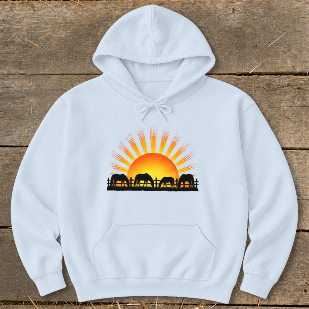 White hoodie with a graphic of horses grazing at sunset.