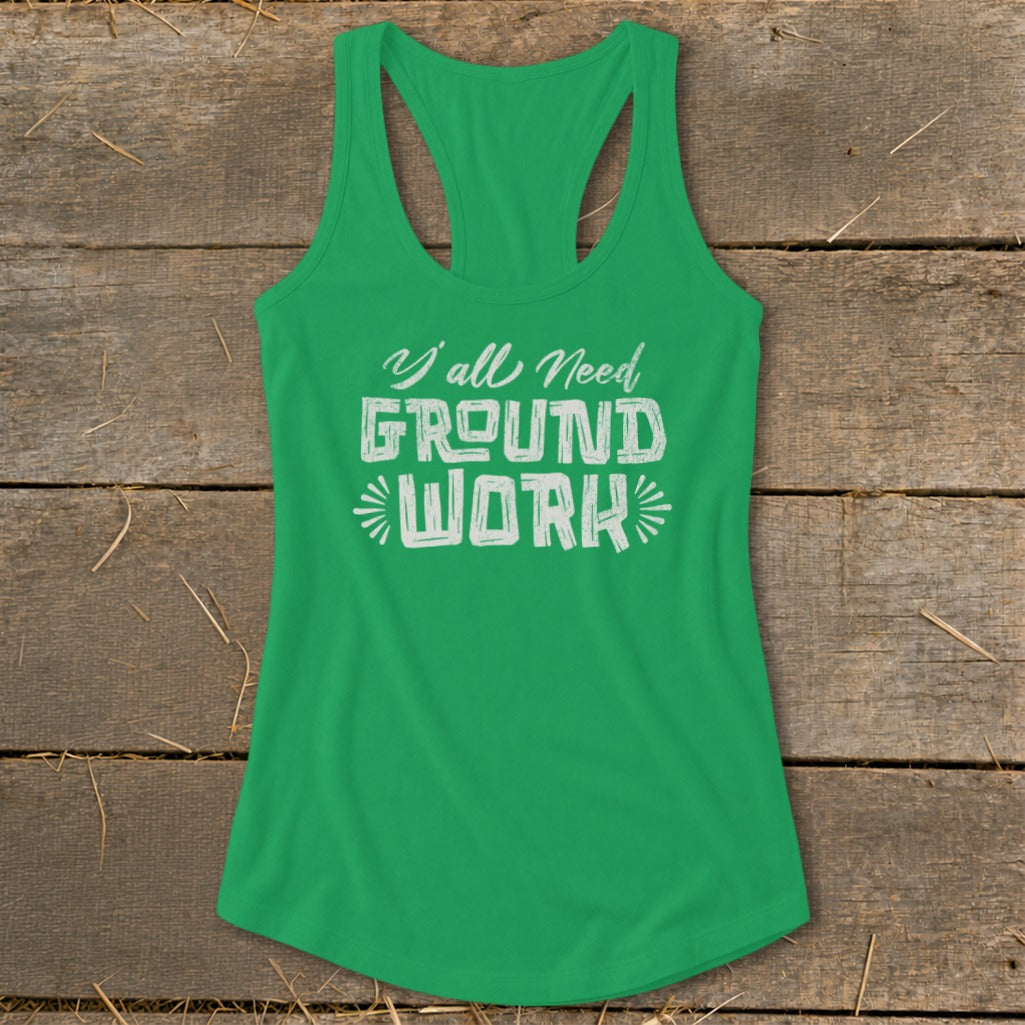 Green tank top with white text reading "Y'all Need GROUND WORK"