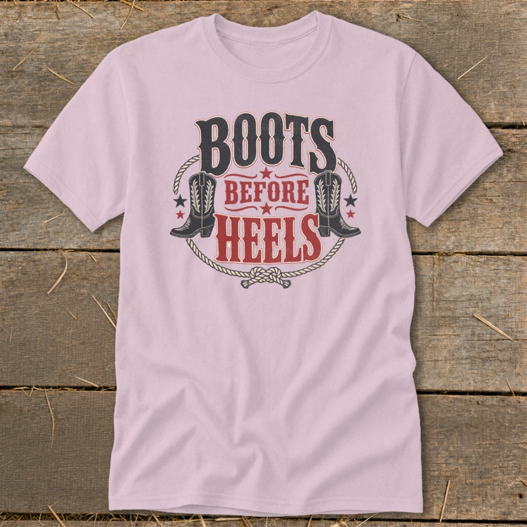 Pink t-shirt with "Boots Before Heels" graphic featuring cowboy boots and rope.