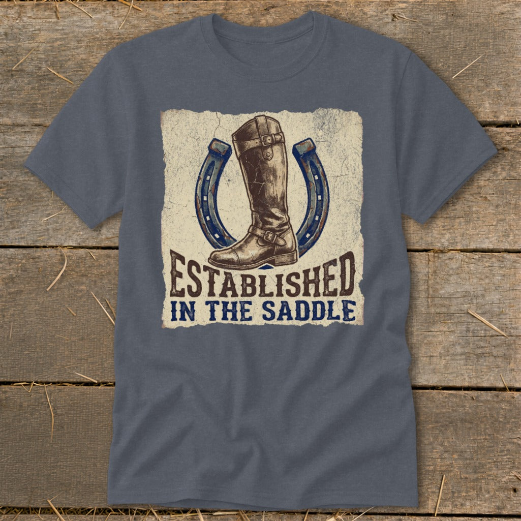 T-shirt with graphic of brown riding boot between two horseshoes and text "Established in the Saddle".