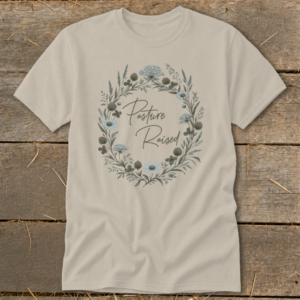 Light beige t-shirt with floral wreath graphic and "Pasture Raised" text.