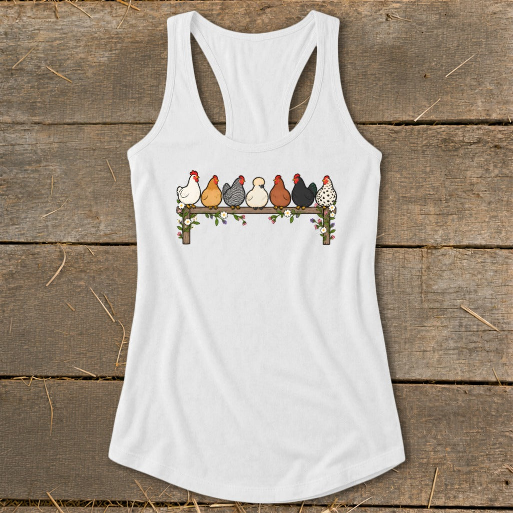 A white racerback tank top featuring an illustration of seven colorful chickens perched on a floral fence.