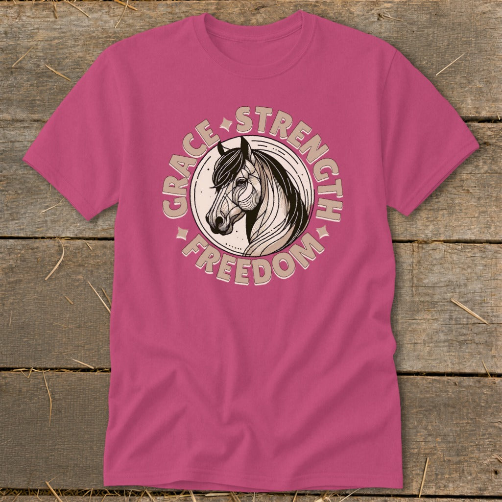 Pink t-shirt with circular horse head graphic and text: grace, strength, freedom.