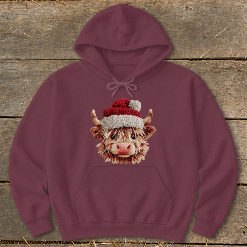 Burgundy hoodie with a fluffy Highland cow wearing a Santa hat graphic.