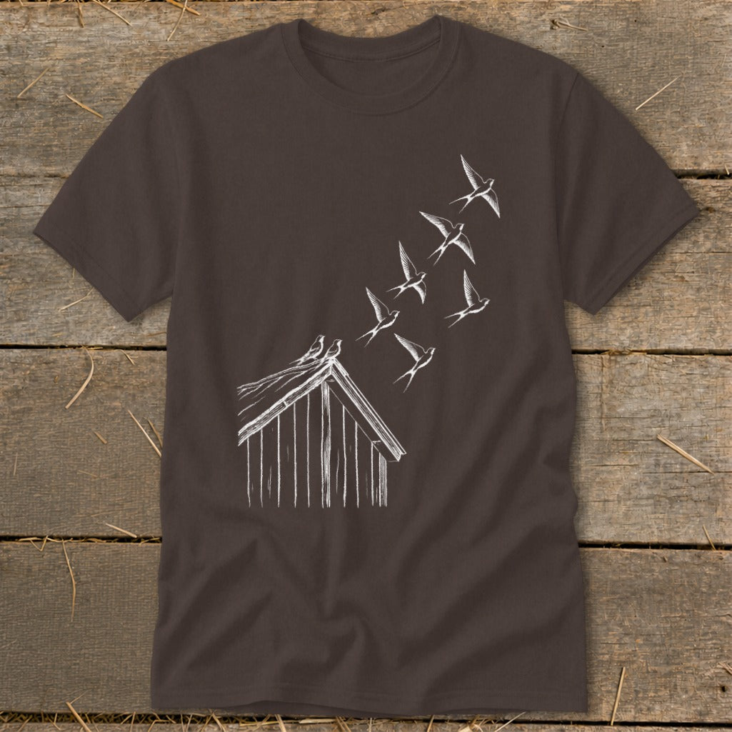 Brown crewneck t-shirt featuring a white line drawing of a barn with birds flying upward.
