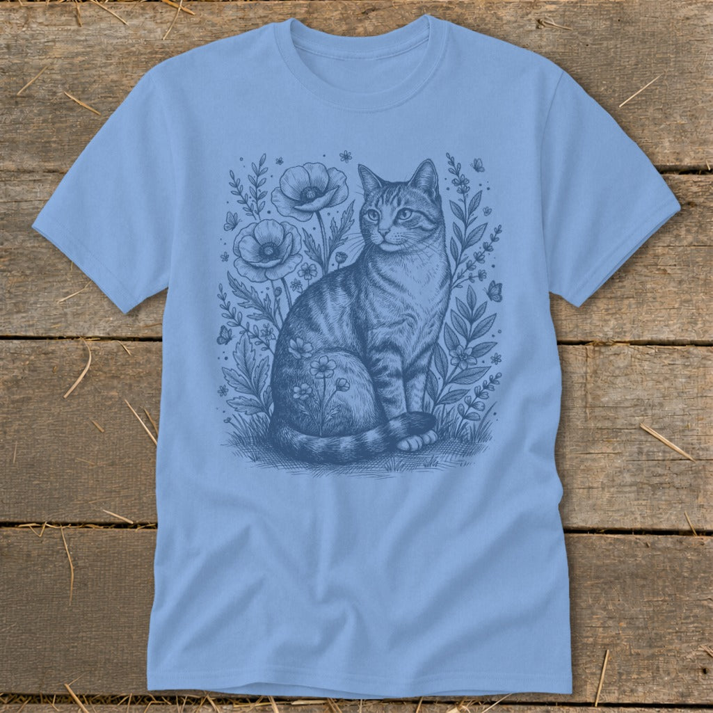 Light blue t-shirt with a sketch of a cat sitting among poppies and butterflies.