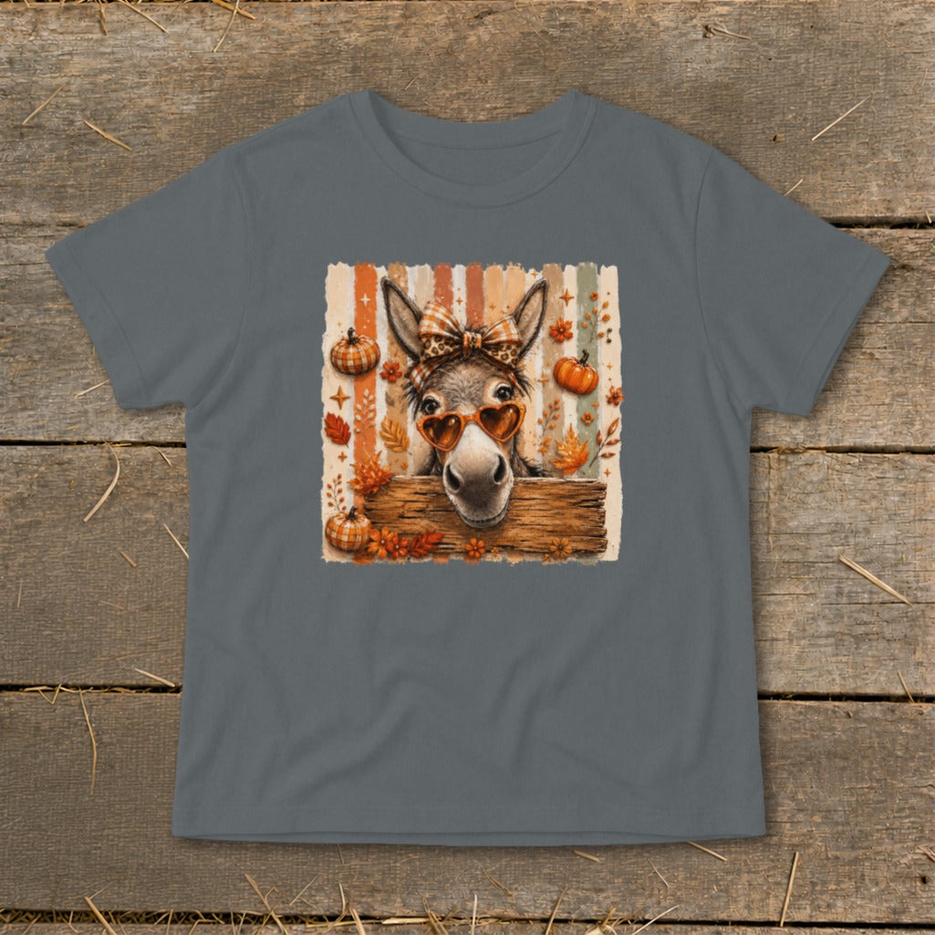 Donkey wearing heart sunglasses and plaid bow with pumpkins and fall leaves.