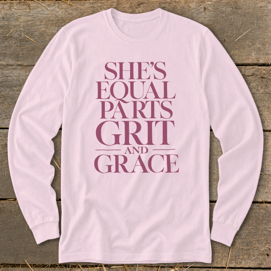 Pink long-sleeve shirt with maroon text "She's Equal Parts Grit and Grace."