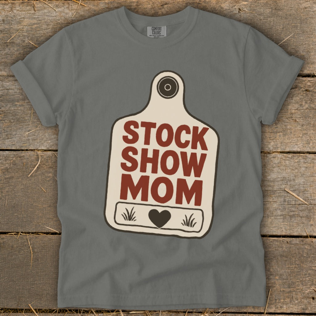 Grey t-shirt with "STOCK SHOW MOM" text and a heart on a tag graphic.