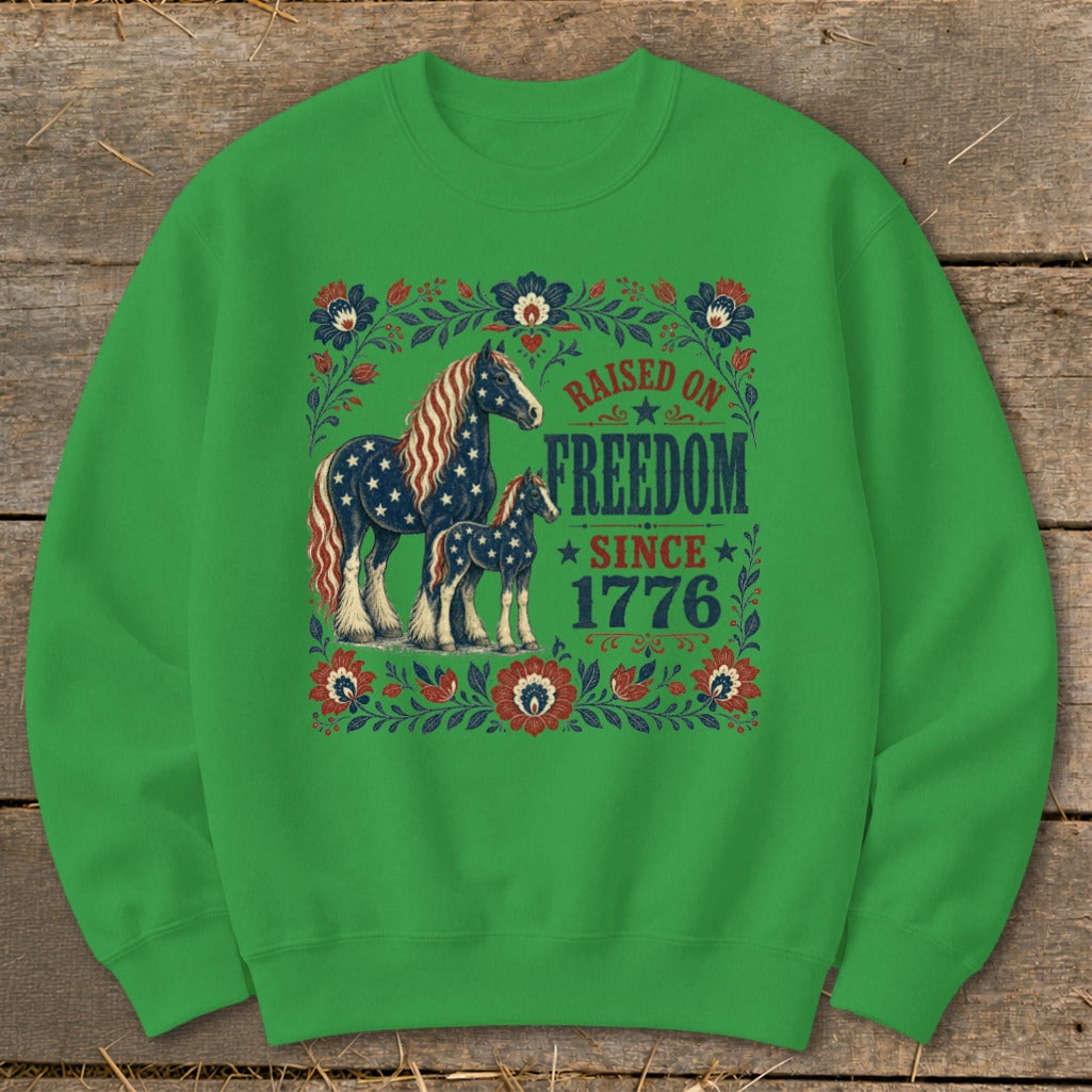 Green sweatshirt with horses and the text "Raised on Freedom Since 1776".