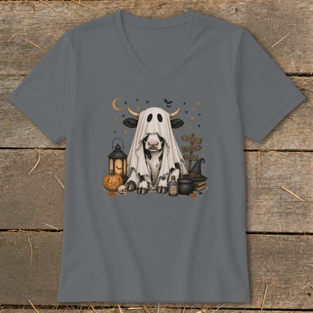 Cow in ghost costume with Halloween decorations and "Spooky Beware Boo!" signs.