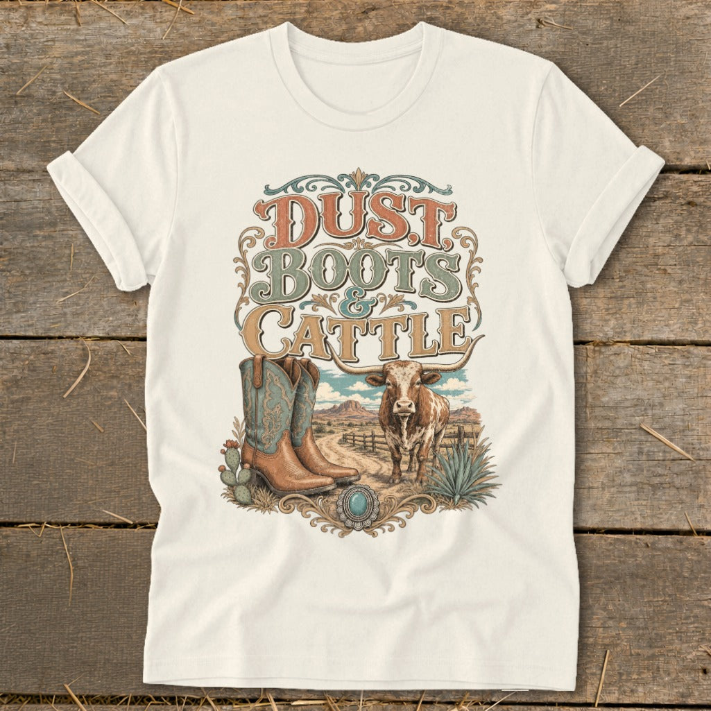 White t-shirt with "Dust Boots & Cattle" graphic, cowboys boots, and steer.