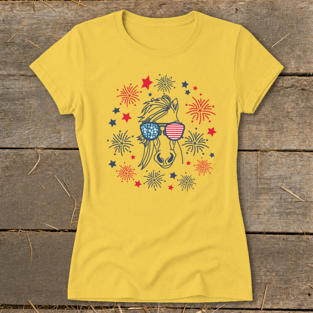 Yellow t-shirt with a horse wearing American flag sunglasses and surrounded by fireworks.