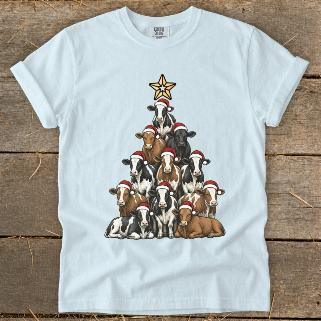 Light blue t-shirt with a Christmas tree made of cows wearing Santa hats.