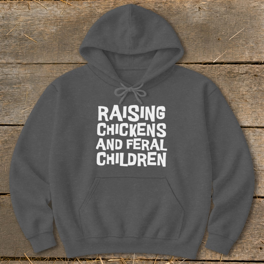 Dark gray hoodie with white text: "RAISING CHICKENS AND FERAL CHILDREN."