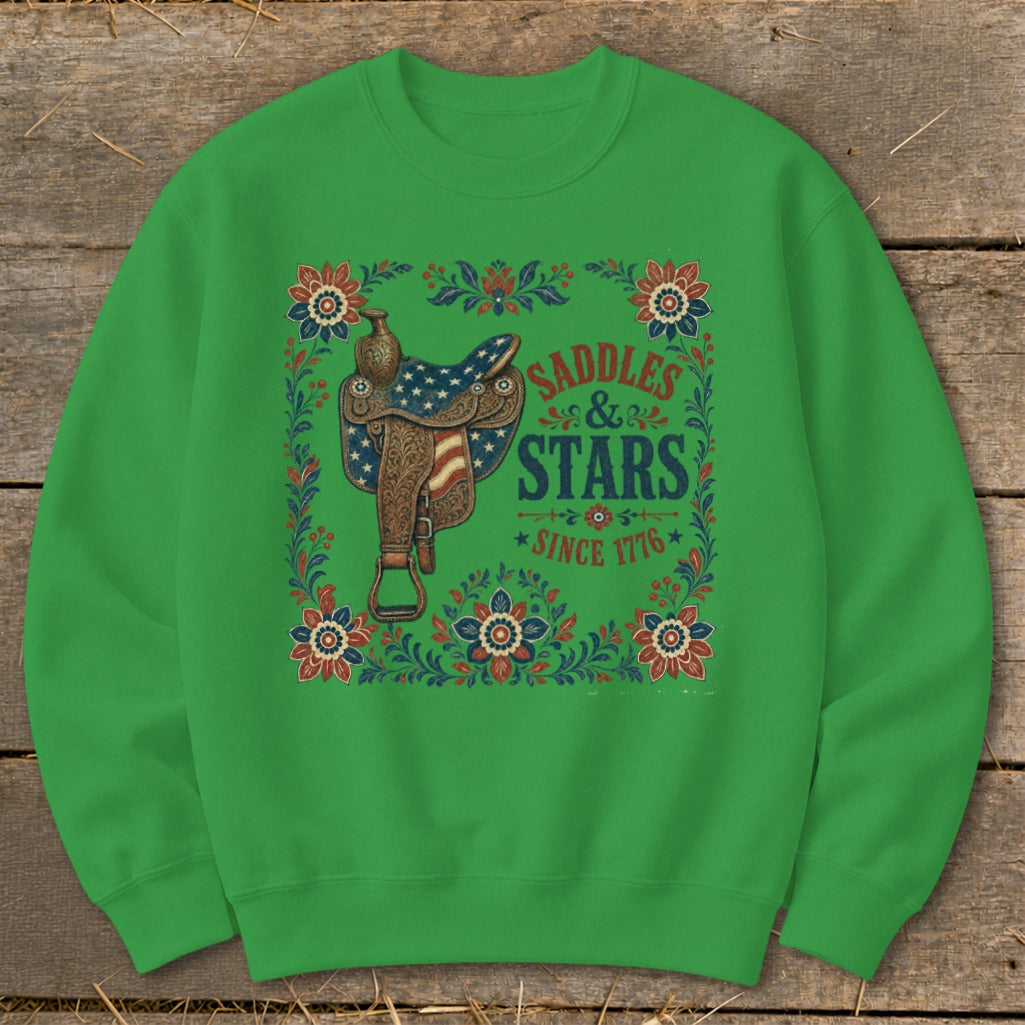 Green sweatshirt with "Saddles & Stars Since 1776" text and patriotic saddle graphic.