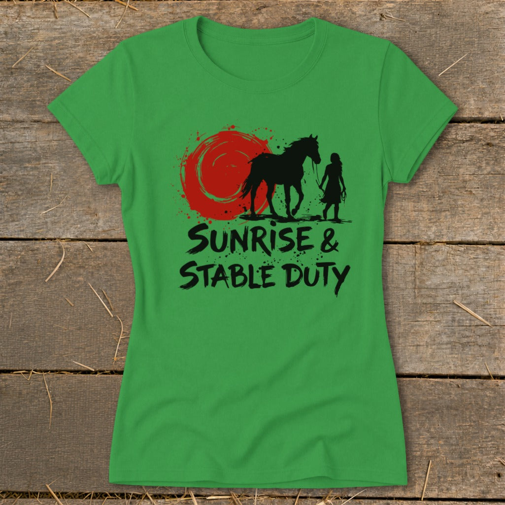 Green t-shirt with silhouette of a horse and person, under a red sunburst, reading "Sunrise & Stable Duty".