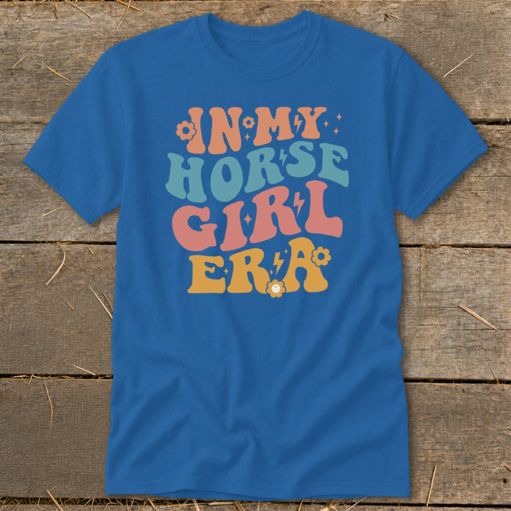 Blue t-shirt with "IN MY HORSE GIRL ERA" text in retro colorful font.