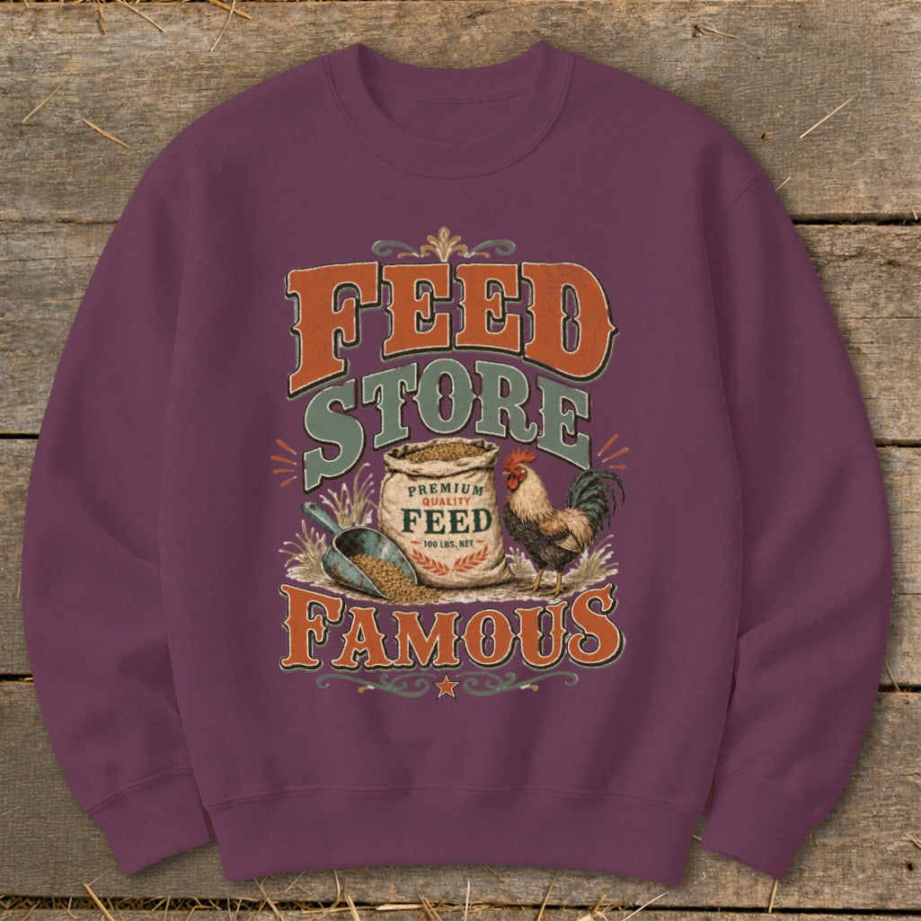 Feed Store Famous graphic with rooster, feed bag, and scoop on purple sweatshirt.