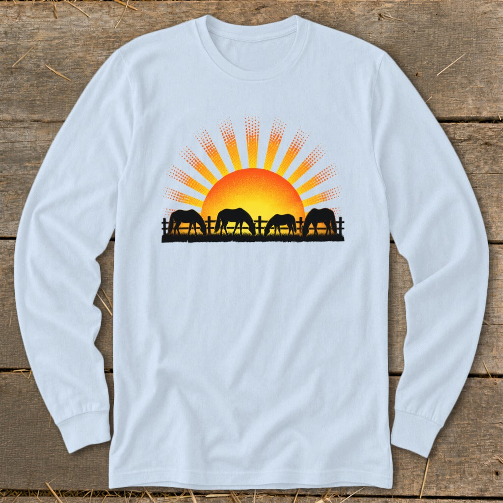 Silhouette of four horses grazing in front of a stylized sunrise and fence.