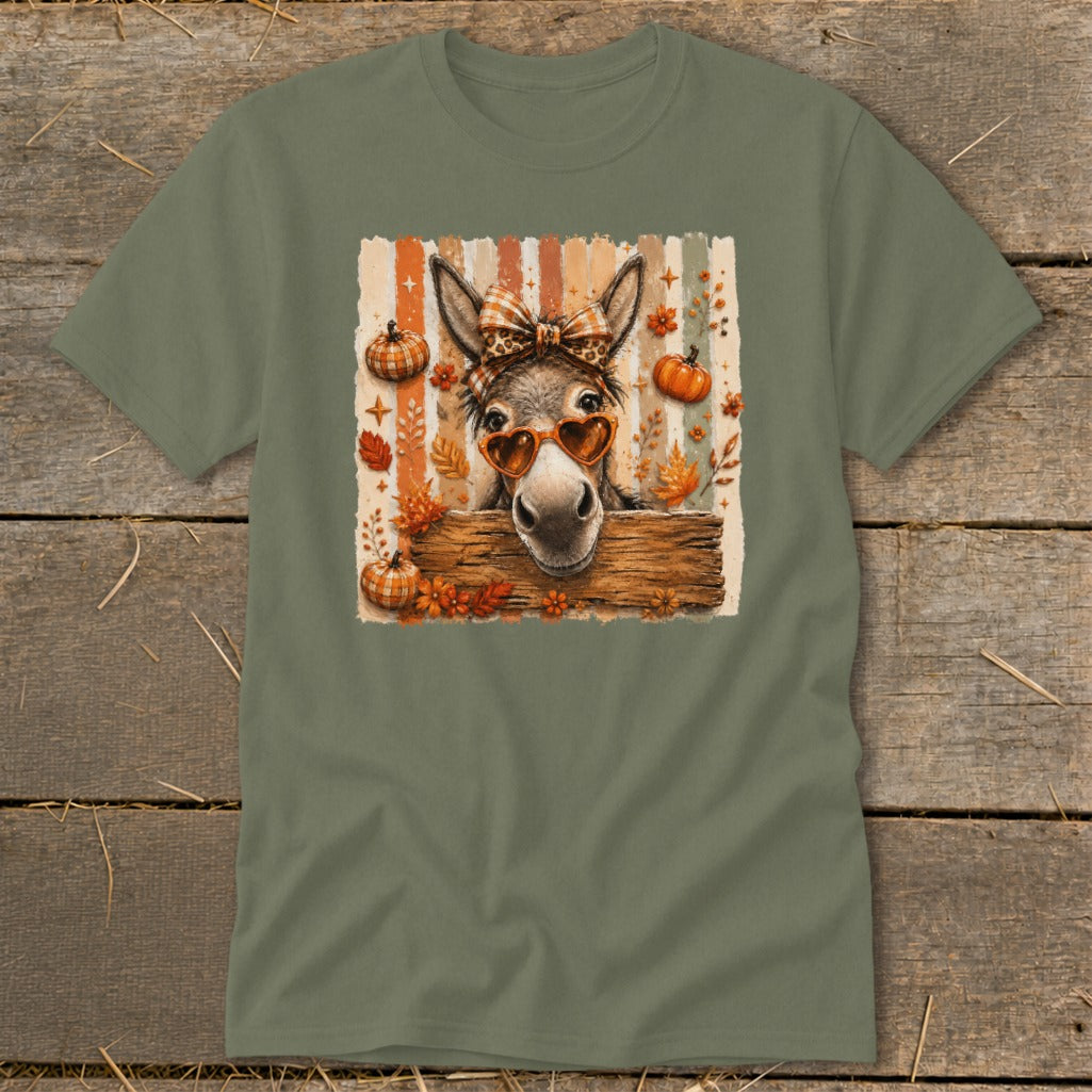 Donkey wearing heart sunglasses and leopard bow against striped background with pumpkins and leaves.