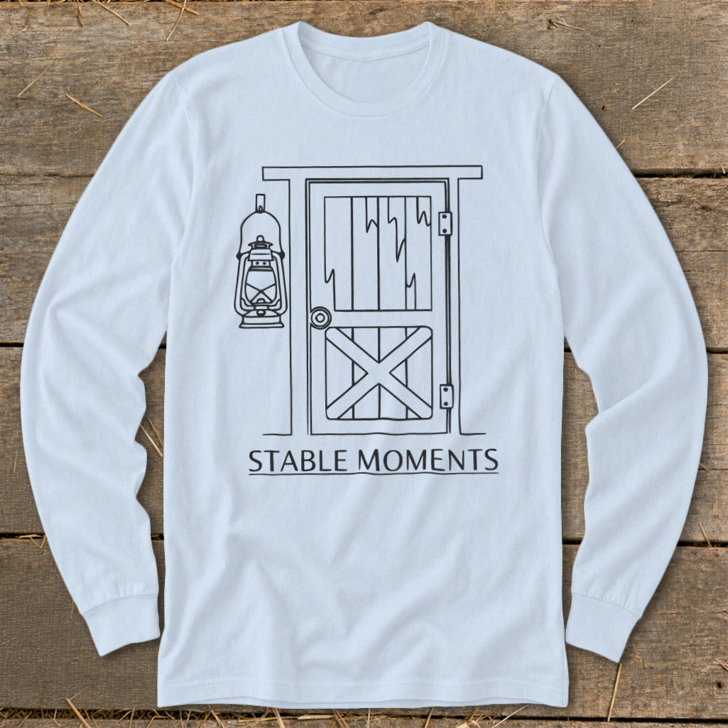 Long sleeve t-shirt with black line drawing of a barn door and lantern, text "STABLE MOMENTS".