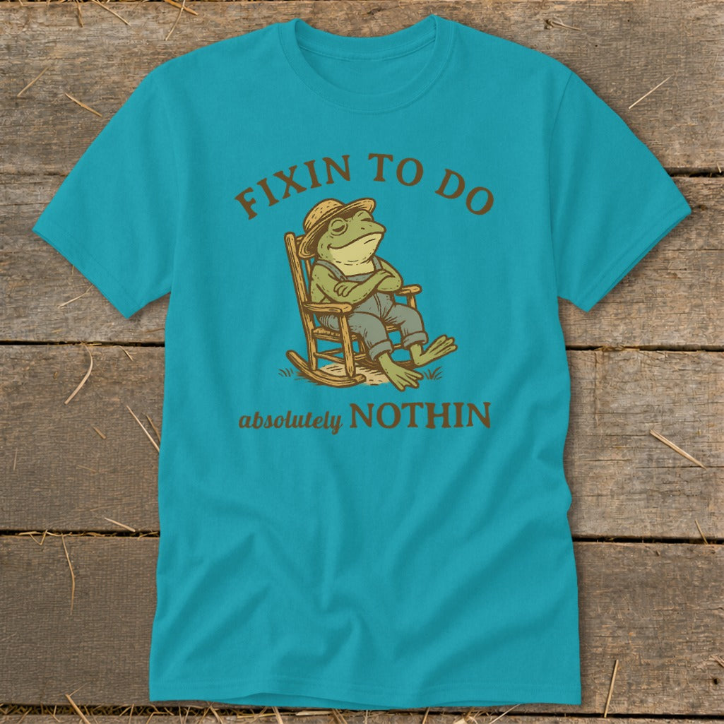 Teal t-shirt with frog in rocking chair, "Fixin to do absolutely NOTHIN" text.