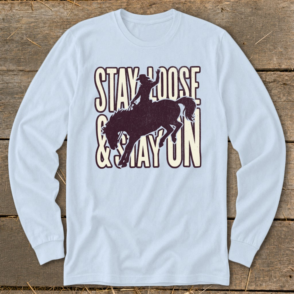 Light blue long-sleeve shirt with "STAY LOOSE & STAY ON" and bucking bronco graphic.
