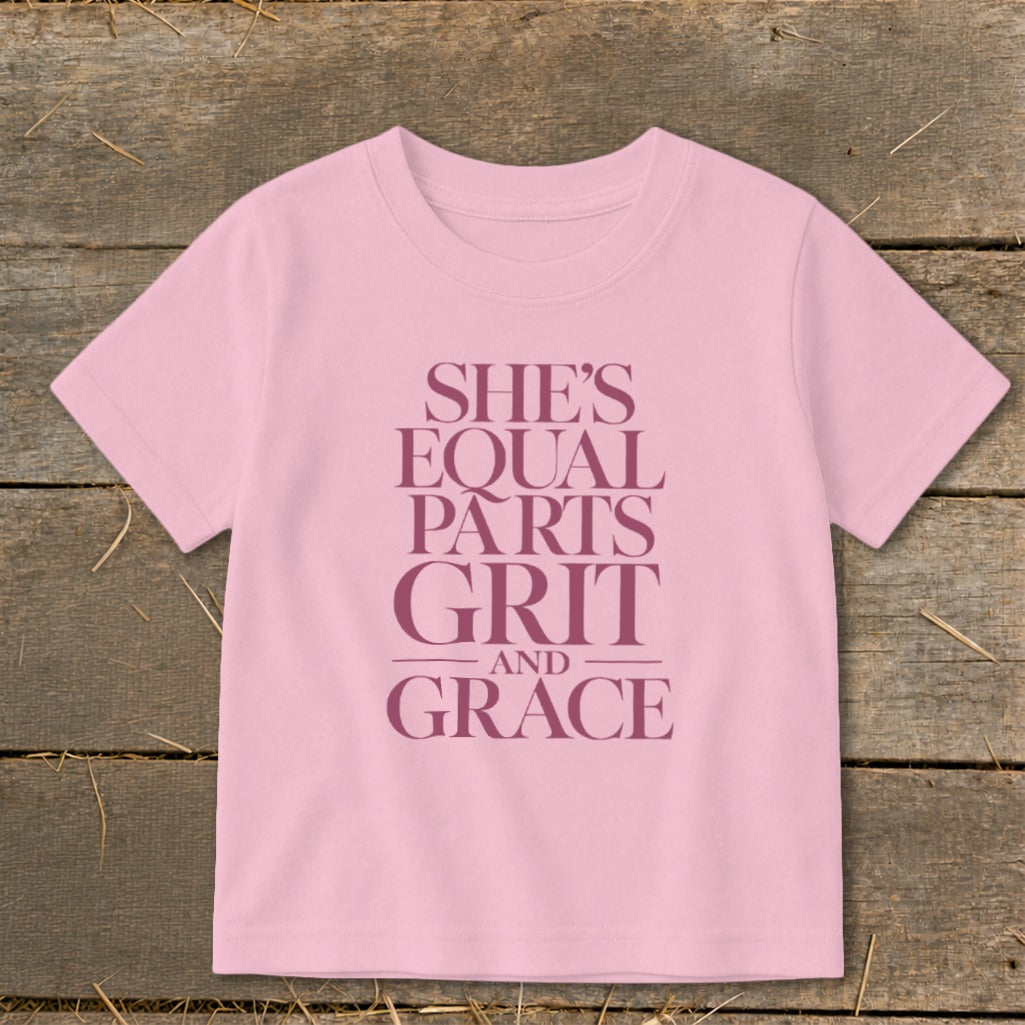 Pink t-shirt with text "She's Equal Parts Grit And Grace."