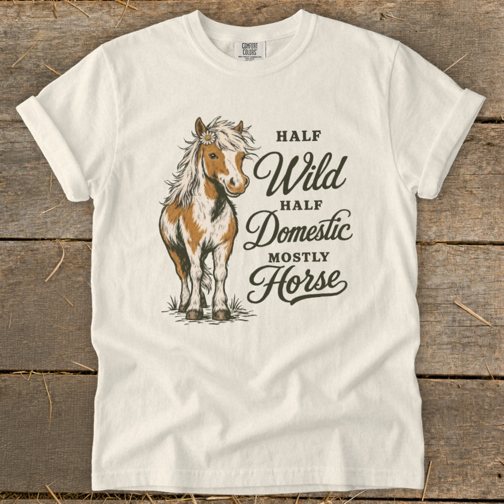 White t-shirt with a brown and white horse illustration and text "Half Wild, Half Domestic, Mostly Horse".