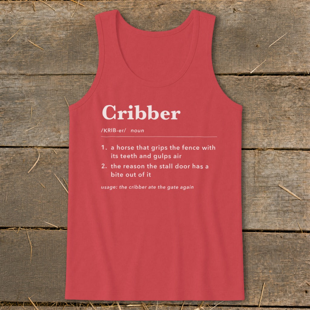 Red tank top printed with a humorous dictionary definition of the word cribber on a wooden background.
