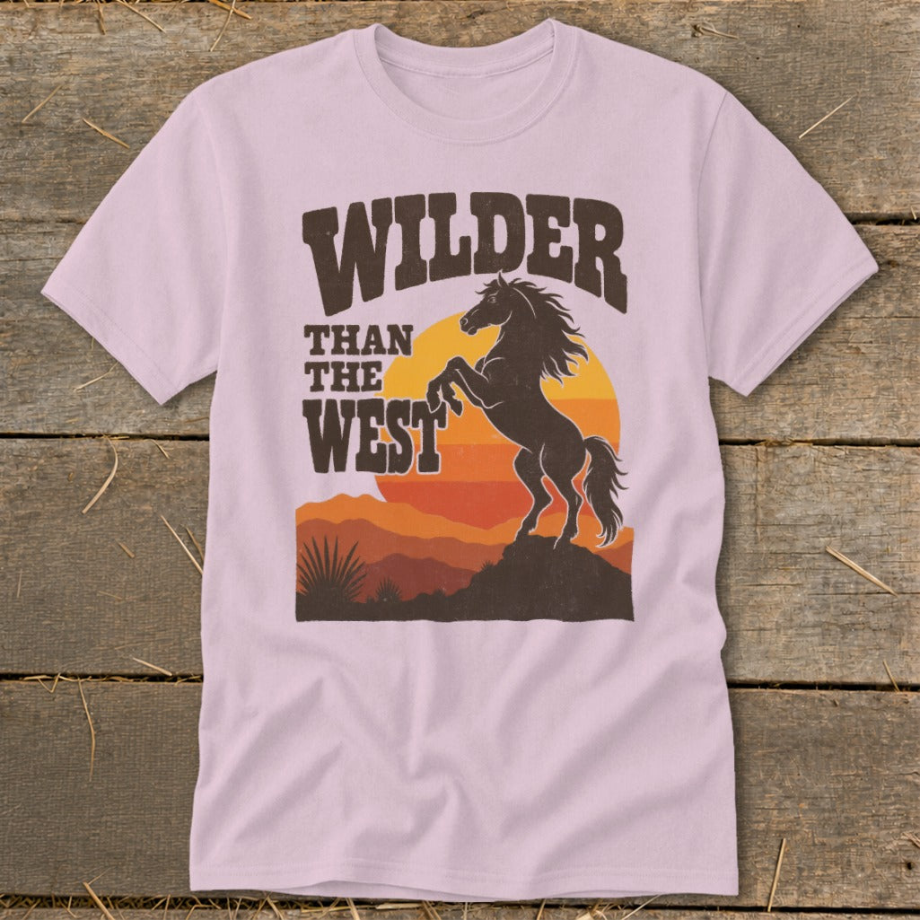 Pink t-shirt with "WILDER THAN THE WEST" text and rearing horse graphic.