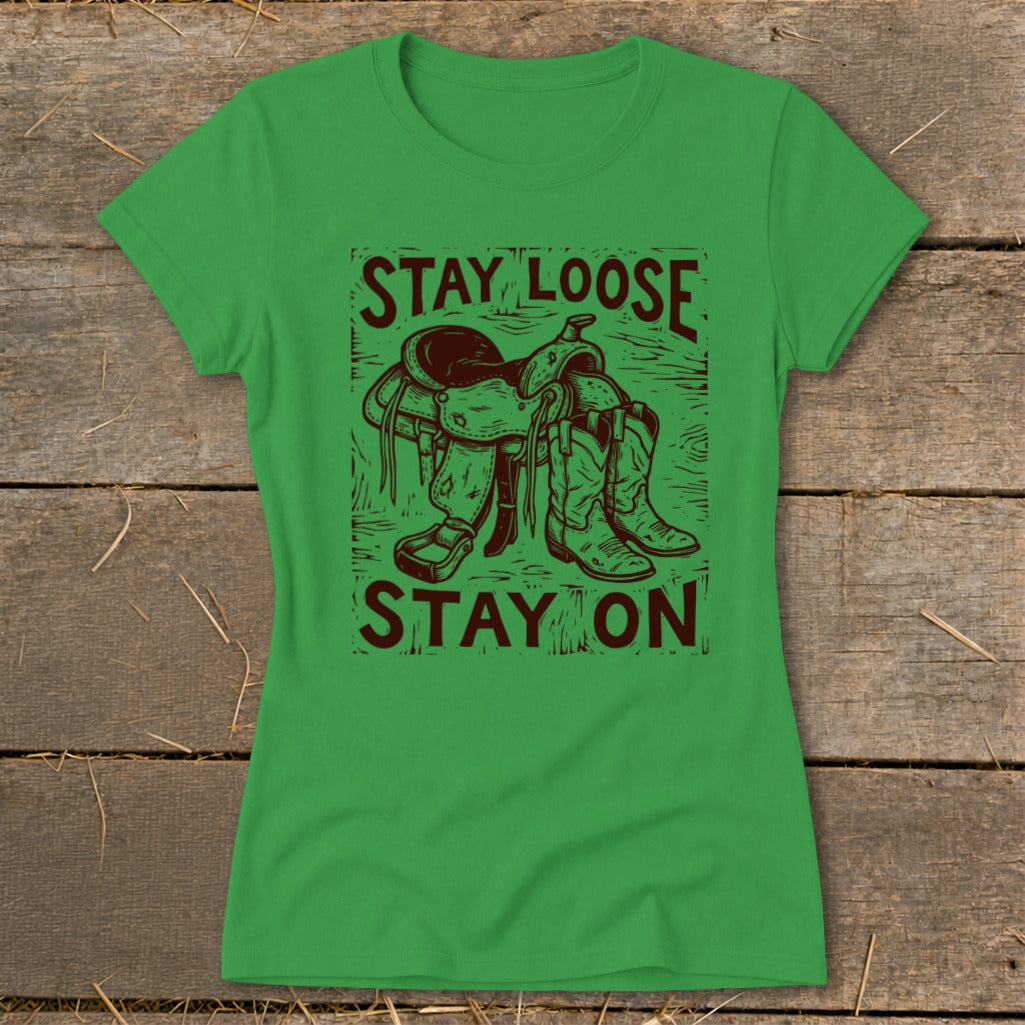 Green t-shirt with brown graphic of saddle and boots, text "STAY LOOSE STAY ON".