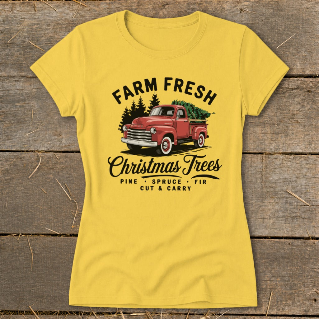 Yellow t-shirt graphic with red truck, "Farm Fresh Christmas Trees" text.
